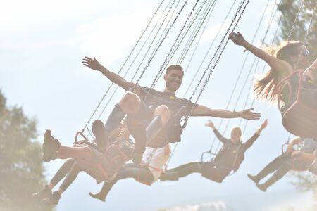 BONTIDA, ROMANIA - JULY 17, 2016: Young people enjoying swing ride, carousel, merry-go-round, highland spinner at Electric Castle Festivalのeditorial素材