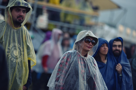 BONTIDA, ROMANIA - JULY 16, 2016: People living heavy rainy days at Electric Castle Festival. After 3 days of raining the area of the festival became extremly muddy and wetのeditorial素材