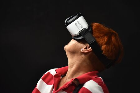 CLUJ-NAPOCA, ROMANIA - AUGUST 6, 2016: Woman tries virtual reality Samsung Gear VR headset and hand...