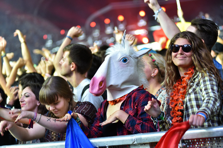 CLUJ-NAPOCA, ROMANIA - AUGUST 8, 2016: Crowd of people partying with raised arms and hands at a Afrojack concert during the Untold Festivalのeditorial素材