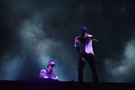 CLUJ-NAPOCA, ROMANIA - AUGUST 8, 2016: Dj Afrojack mixing live on the stage during the Untold Festival. Beautiful stage lights in the backgroundのeditorial素材