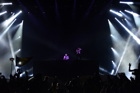 CLUJ-NAPOCA, ROMANIA - AUGUST 8, 2016: Dj Afrojack mixing live on the stage during the Untold Festival. Beautiful stage lights in the backgroundのeditorial素材