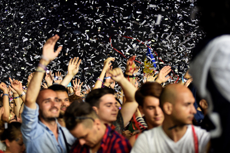 CLUJ-NAPOCA, ROMANIA - AUGUST 8, 2016: Crowd of people partying with raised arms and hands at a Afrojack concert during the Untold Festivalのeditorial素材