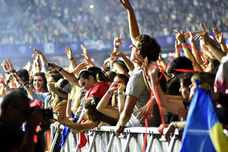 CLUJ-NAPOCA, ROMANIA - AUGUST 8, 2016: Crowd of people partying with raised arms and hands at a Afrojack concert during the Untold Festivalのeditorial素材