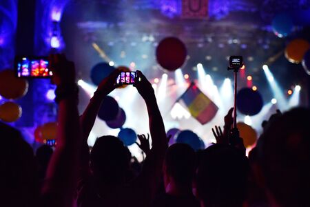 CLUJ-NAPOCA, ROMANIA - AUGUST 6, 2016: People taking photos with smart phones at a Dj Twoloud live concert at Untold festivalのeditorial素材