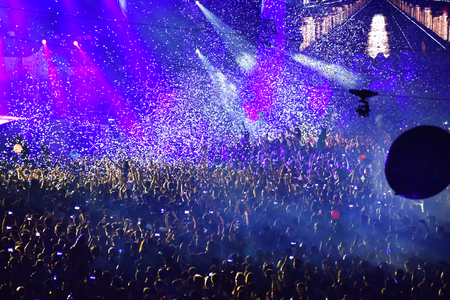 CLUJ-NAPOCA, ROMANIA - AUGUST 7, 2016: Confetti cannons throwing confetti from the stage over the crowd at a Dj Lost Frequency concert at the Untold Festivalのeditorial素材