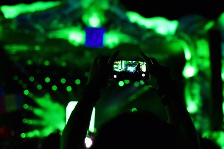 CLUJ-NAPOCA, ROMANIA - AUGUST 6, 2016: People taking photos with smart phones at a Dj Twoloud live concert at Untold festivalのeditorial素材