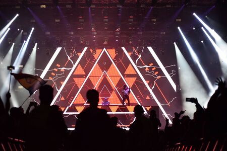 CLUJ-NAPOCA, ROMANIA - AUGUST 8, 2016: Dj Afrojack mixing live on the stage during the Untold Festival. Beautiful stage lights in the backgroundのeditorial素材