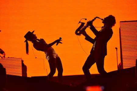 CLUJ-NAPOCA, ROMANIA - AUGUST 7, 2016: Silhouette of singer Cleo Panther (left) and saxophone player from Parov Stelar Band performing live on the stage at Untold Festivalのeditorial素材