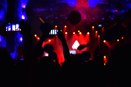 CLUJ-NAPOCA, ROMANIA - AUGUST 6, 2016: People taking photos with smart phones at a Dj Twoloud live concert at Untold festivalのeditorial素材