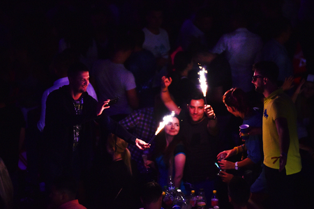 CLUJ NAPOCA, ROMANIA - JULY, 8, 2016: Man from the crowd holding burning torch in his hands at a live concert during Untold festivalのeditorial素材