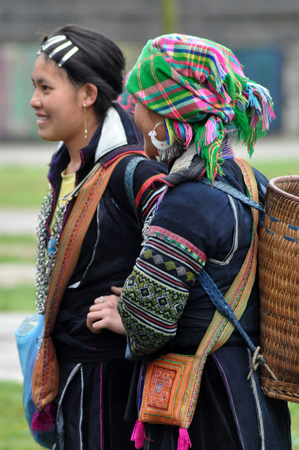 SAPA, VIETNAM - FEBRUARY 22, 2013: Hmong women at Bac Ha market in Northern Vietnam. Bac Ha is hilltribe market where people come to trade for goods in traditional costumesのeditorial素材