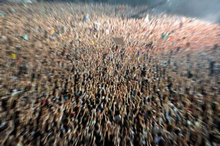 Blurred crowd partying at a music festival. Zoom in effect