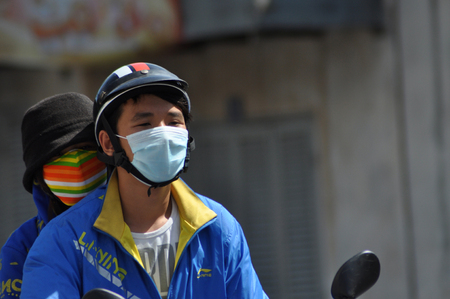 HO CHI MINH, VIETNAM - FEBRUARY 16, 2013: Chaotic road traffic in Saigon, Vietnam. In the biggest city in Southern Vietnam are more than 4 mil. motorbikes, the traffic is often congested and the air is pollutedのeditorial素材