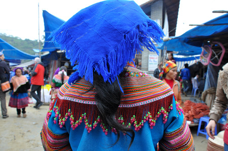 BAC HA, SA PA, VIETNAM - FEBRUARY 23, 2013: Flower Hmong minority people in traditional dress enjoying the weekend and buying food supplies for the upcoming week in the marketのeditorial素材