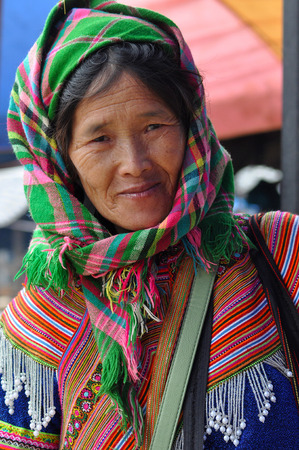 BAC HA, SA PA, VIETNAM - FEBRUARY 23, 2013: Flower Hmong minority people in traditional dress enjoying the weekend and buying food supplies for the upcoming week in the marketのeditorial素材