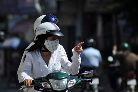 HO CHI MINH, VIETNAM - FEBRUARY 16, 2013: Chaotic road traffic in Saigon, Vietnam. In the biggest city in Southern Vietnam are more than 4 mil. motorbikes, the traffic is often congested and the air is pollutedのeditorial素材