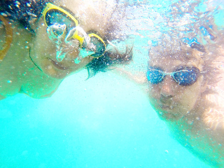 Underwater photo of a young couple diving in the seaの写真素材
