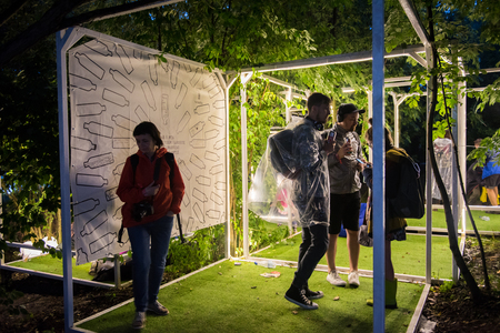 BONTIDA, ROMANIA - JULY 15, 2017: People relaxing in a special chilling natural area decorated with small led lamps at Electric Castle festivalのeditorial素材