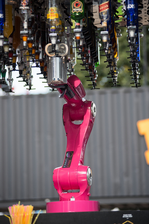 BONTIDA, ROMANIA - JULY 16, 2017: Makr Shakr World's first robotic bar system preparing drinks at Electric Castle festival. Cocktails served by robotic armsのeditorial素材