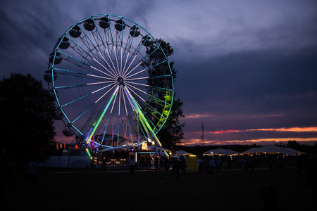 BONTIDA, ROMANIA - JULY 14, 2017: People of Electric Castle festival enjoying a ride at night on the Giant ferris wheelのeditorial素材
