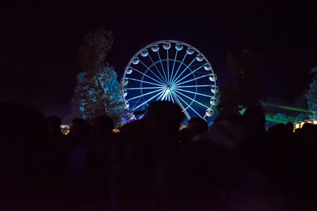 BONTIDA, ROMANIA - JULY 14, 2017: People of Electric Castle festival enjoying a ride at night on the Giant ferris wheelのeditorial素材