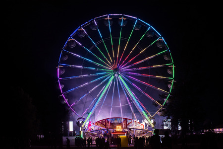 BONTIDA, ROMANIA - JULY 14, 2017: People of Electric Castle festival enjoying a ride at night on the Giant ferris wheelのeditorial素材