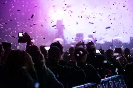 BONTIDA, ROMANIA - JULY 16, 2017: Confetti cannons throwing confetti over the partying crowd at a concert at Electric Castle Festivalのeditorial素材