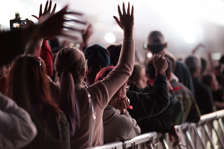 BONTIDA, ROMANIA - JULY 7, 2015: Crowd of cheering people with arms outstretched partying at an EDM concert performed by Duke Dumont at Electric Castle festivalのeditorial素材