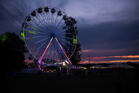 BONTIDA, ROMANIA - JULY 14, 2017: People of Electric Castle festival enjoying a ride at night on the Giant ferris wheelのeditorial素材
