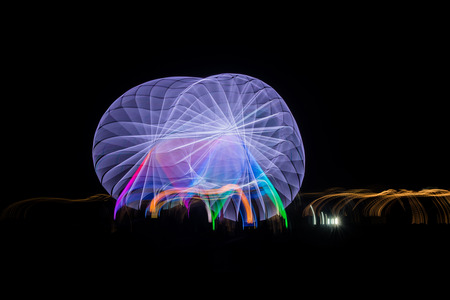 Blurred giant wheel, ferris photographed with long exposure technique at night. Motion blurの写真素材