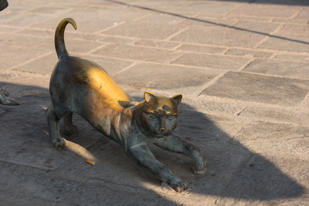 MARSAXLOKK, MALTA - AUGUST 23, 2017: Bronze statue representing a cat at the harbor bay of Marsaxlokk in Malta islandのeditorial素材