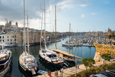 VALLETTA, MALTA - AUGUST 23, 2017: Boats, ships and yachts anchoring in Birgu harbor, one of the biggest port from the Three Cities of Maltaのeditorial素材