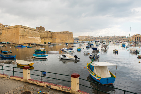 VALLETTA, MALTA - AUGUST 23, 2017: Boats, ships and yachts anchoring in Birgu harbor, one of the biggest port from the Three Cities of Maltaのeditorial素材
