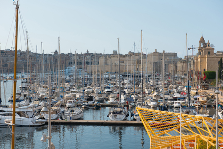 VALLETTA, MALTA - AUGUST 23, 2017: Boats, ships and yachts anchoring in Birgu harbor, one of the biggest port from the Three Cities of Maltaのeditorial素材