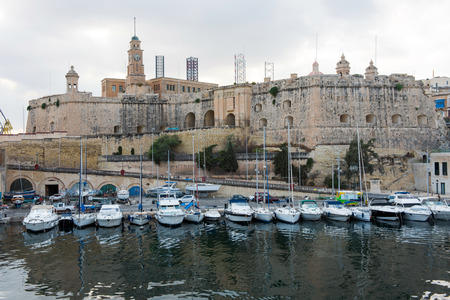 VALLETTA, MALTA - AUGUST 23, 2017: Boats, ships and yachts anchoring in Birgu harbor, one of the biggest port from the Three Cities of Maltaのeditorial素材