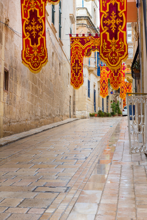 VALLETTA, MALTA - AUGUST 23, 2017: The Feast of St. Dominic is celebrated in the town of Vittoriosa (Birgu) in Malta. The streets are ornated with religious flagsのeditorial素材