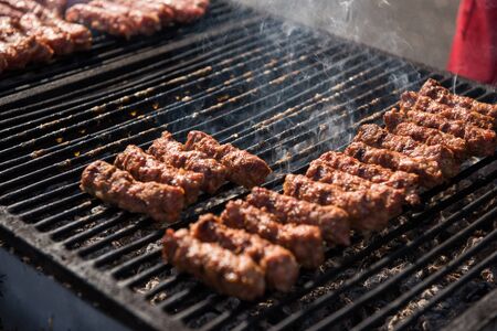 Traditional Romanian food. Meat balls called mici or mititei on grillの写真素材