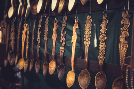 Vintage ornamental wooden spoons hanging in a fairの写真素材
