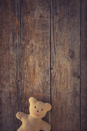 Adorable teddy bear on toned wooden background. Space for textの写真素材