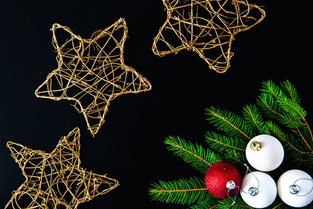 Christmas background with balls, golden snowflakes and fir tree branches on blackの写真素材