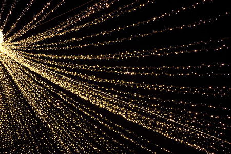 Small led lights hanging in a row, light background 