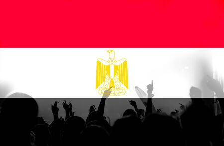 Crowd of football, soccer fans with raised arms with blending Egypt flagの写真素材