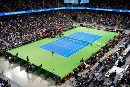 CLUJ NAPOCA, ROMANIA - FEBRUARY 10, 2018: Romania playing tennis Canada during a Fed Cup match in the Polivalenta Hall indoor court. Crowd of people, fans supporting their teamのeditorial素材