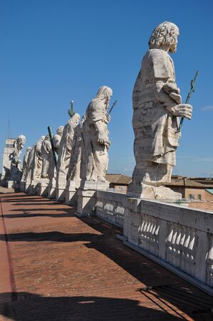 The roof of Maderno's Facade of Saint Peter's Basilica, features statues of Jesus and 11 of the Apostles along with John the Baptist. Vatican cityの写真素材