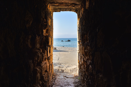 Sea view through ancient tunnelの写真素材