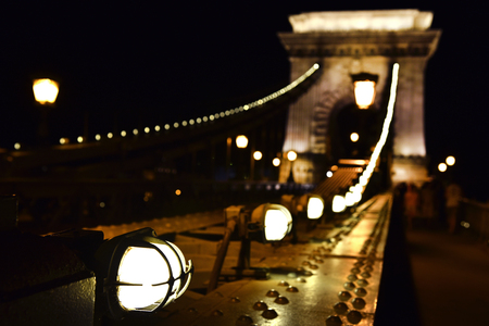 Lights on the Chain Bridge in Budapest, Hungary glowing in the night. Iron detailsの写真素材