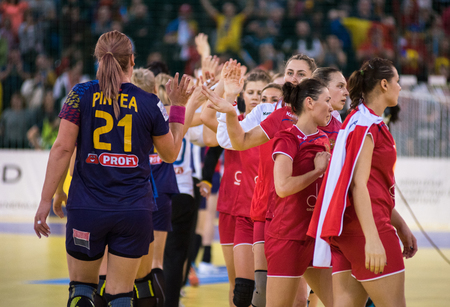 CLUJ NAPOCA, ROMANIA - MARCH 25, 2018: Woman players of Romania celebrating victory against Russia at Handball 2018 European Championship Qualificationのeditorial素材