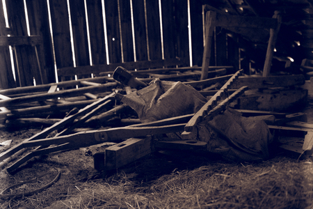 Vintage wooden objects in abandoned barn. Traditional tools in a shedの写真素材