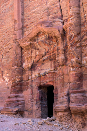Entrance of a cave, royal tomb in Petra, Jordan. Underground ancient rock carving, used as burial placeの写真素材